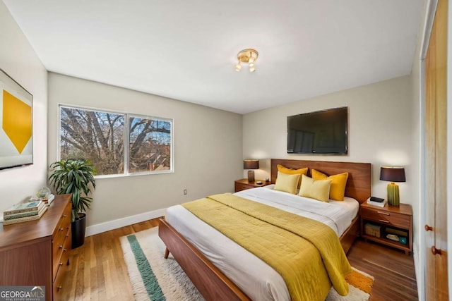 bedroom featuring wood finished floors and baseboards