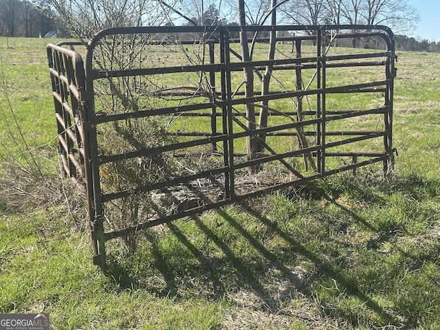 view of gate with a rural view