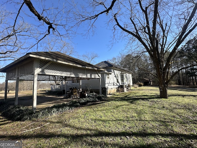 view of property exterior with a carport and a lawn