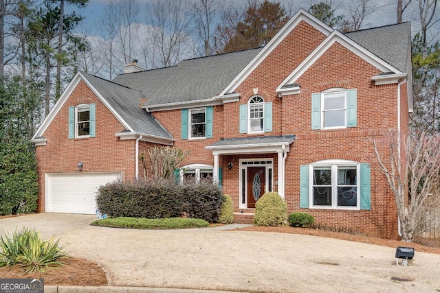 view of front of property with brick siding, a chimney, a shingled roof, an attached garage, and driveway