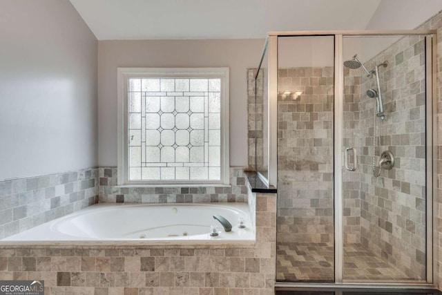 full bathroom featuring a whirlpool tub and a stall shower