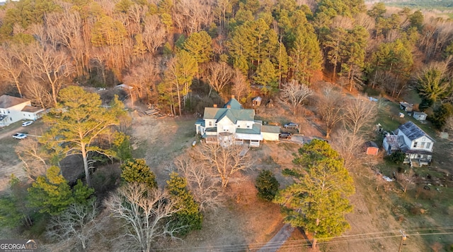 birds eye view of property featuring a wooded view