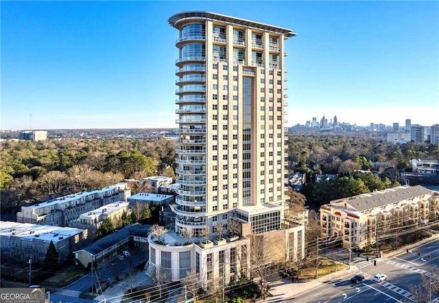 view of property with a view of city and uncovered parking