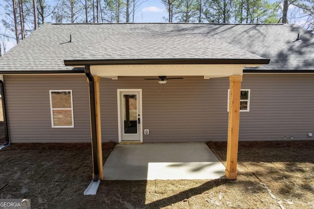 rear view of house with a shingled roof, a patio, and ceiling fan