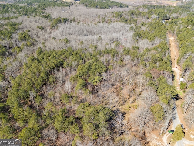 bird's eye view featuring a wooded view