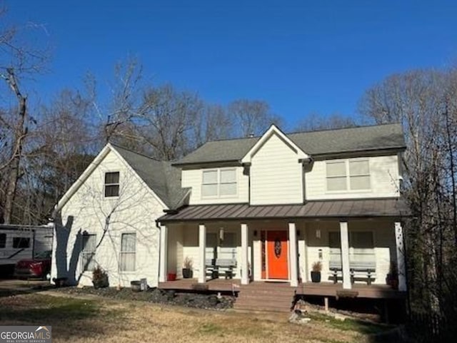 view of front of house with a standing seam roof, metal roof, and a porch