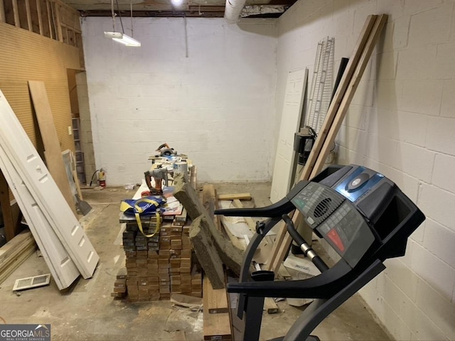 basement with concrete block wall and visible vents