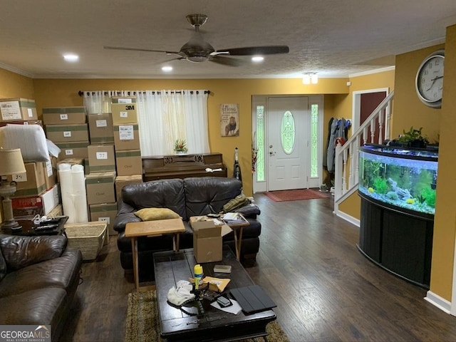 living area with ornamental molding, wood finished floors, and stairs