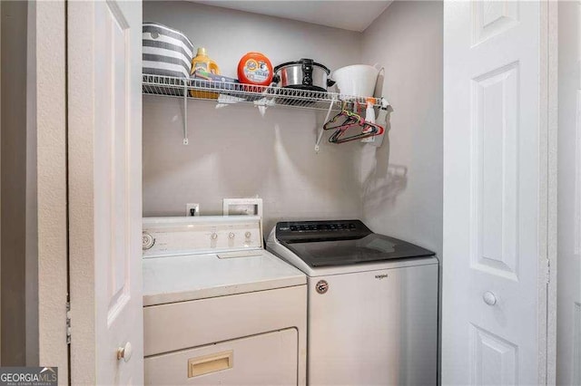 clothes washing area featuring laundry area and separate washer and dryer