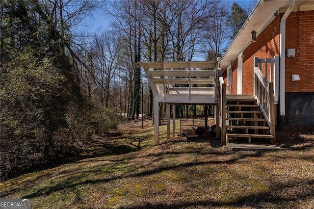 view of yard with a wooden deck and stairs