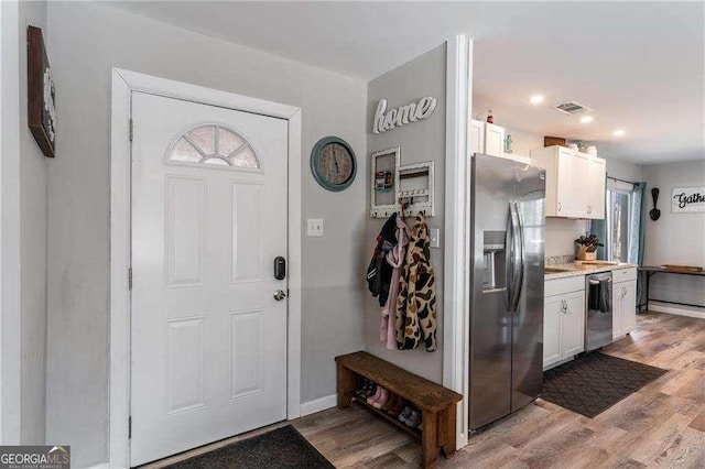 entrance foyer with baseboards, visible vents, and light wood-style floors