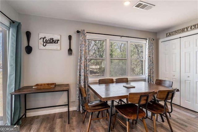 dining room with visible vents and wood finished floors