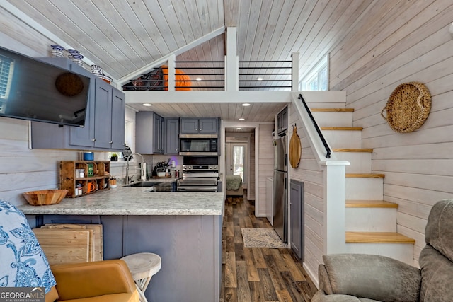 kitchen featuring wooden ceiling, stainless steel appliances, a sink, a wealth of natural light, and open shelves