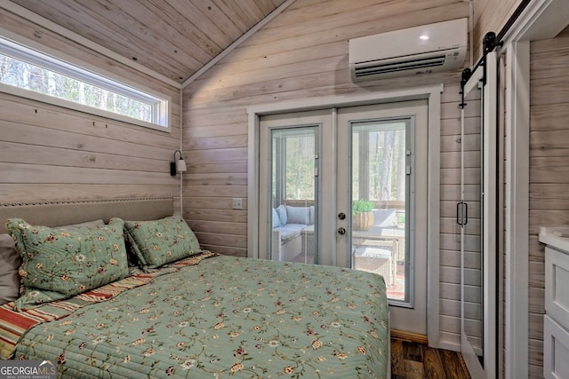 bedroom featuring multiple windows, a barn door, a wall mounted AC, and access to outside