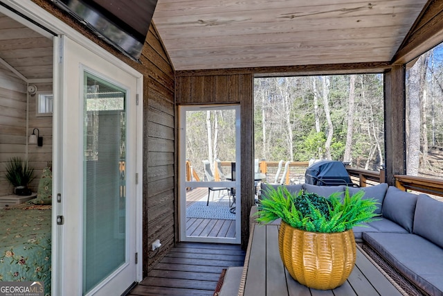 sunroom / solarium featuring lofted ceiling and wood ceiling