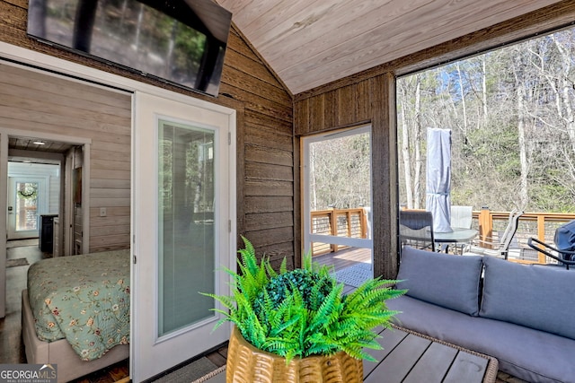 sunroom featuring wooden ceiling and vaulted ceiling