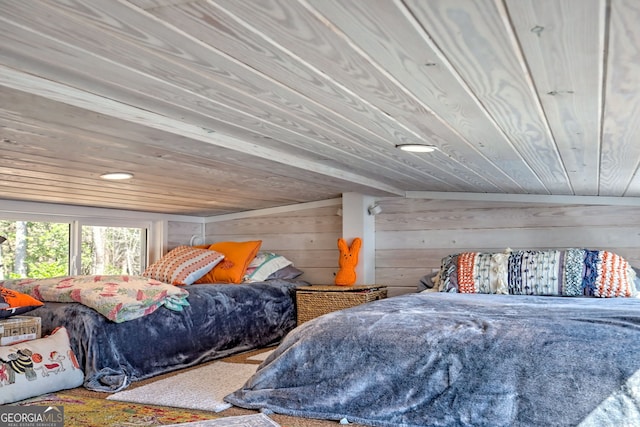 bedroom featuring wooden ceiling and wood walls