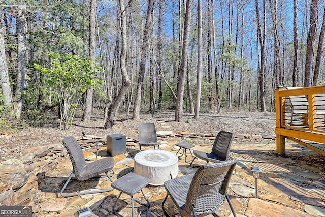 view of patio / terrace with a wooded view