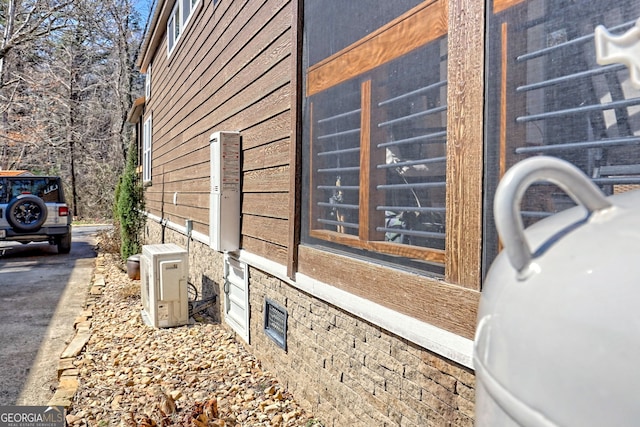 view of side of home featuring ac unit and a sink