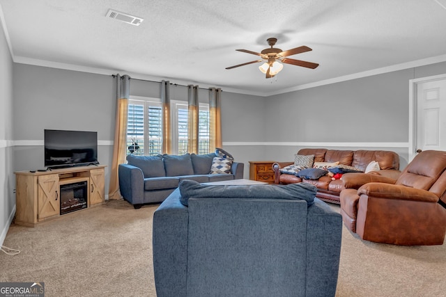 living area with visible vents, light colored carpet, ceiling fan, a textured ceiling, and crown molding