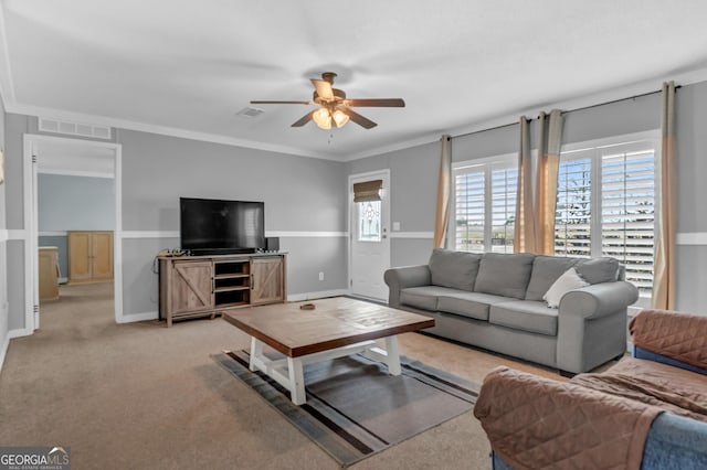 living area featuring light carpet, visible vents, baseboards, ceiling fan, and ornamental molding