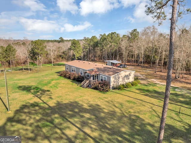 birds eye view of property featuring a view of trees