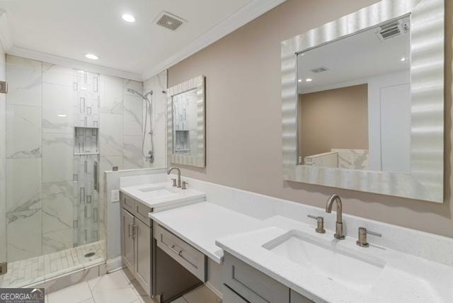 bathroom featuring crown molding, a marble finish shower, recessed lighting, visible vents, and vanity