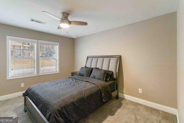 bedroom featuring light carpet, visible vents, and baseboards