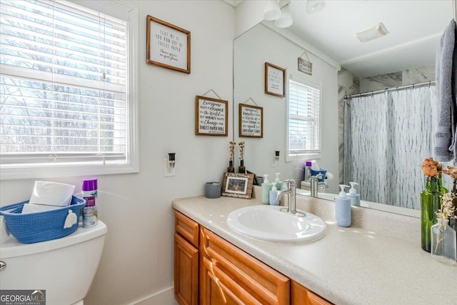 full bathroom with toilet, curtained shower, and vanity