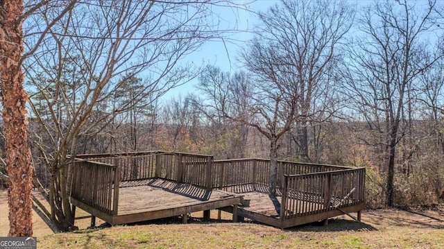 wooden terrace featuring a forest view