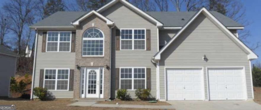 view of front of property with concrete driveway and an attached garage