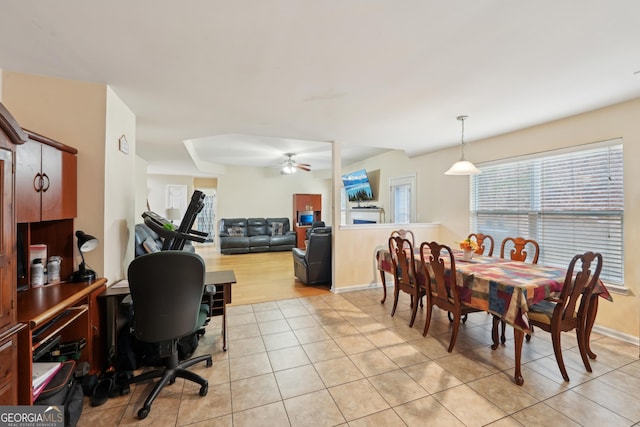 dining room featuring light tile patterned floors, baseboards, and ceiling fan