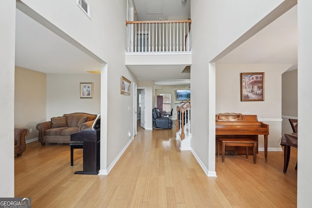entrance foyer featuring visible vents, baseboards, and wood finished floors