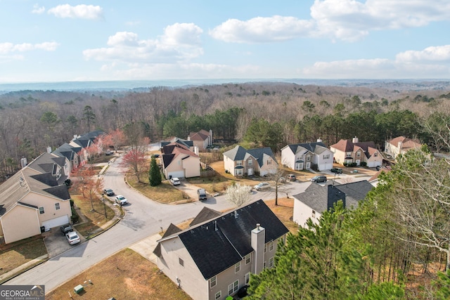 drone / aerial view with a view of trees and a residential view