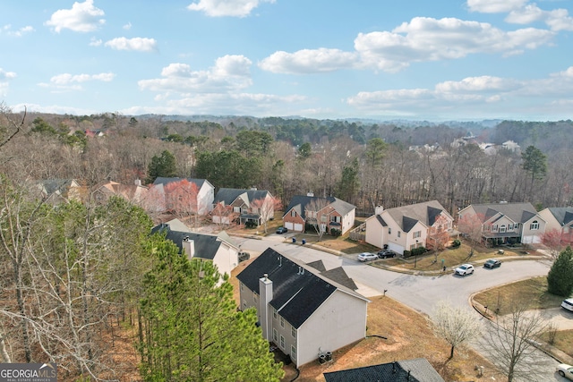 drone / aerial view with a view of trees and a residential view