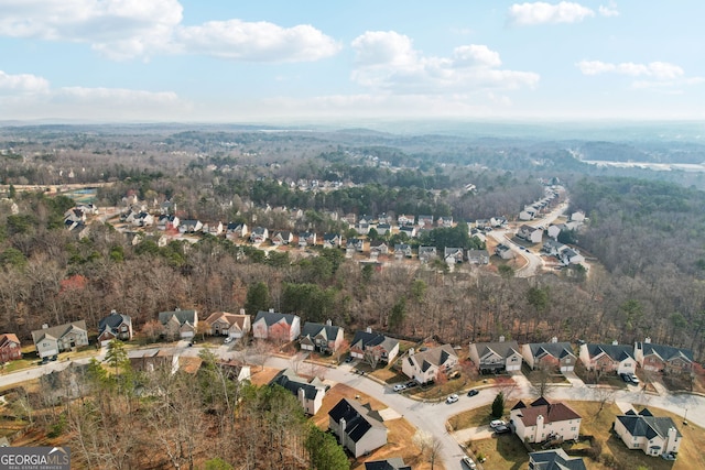 bird's eye view featuring a view of trees and a residential view