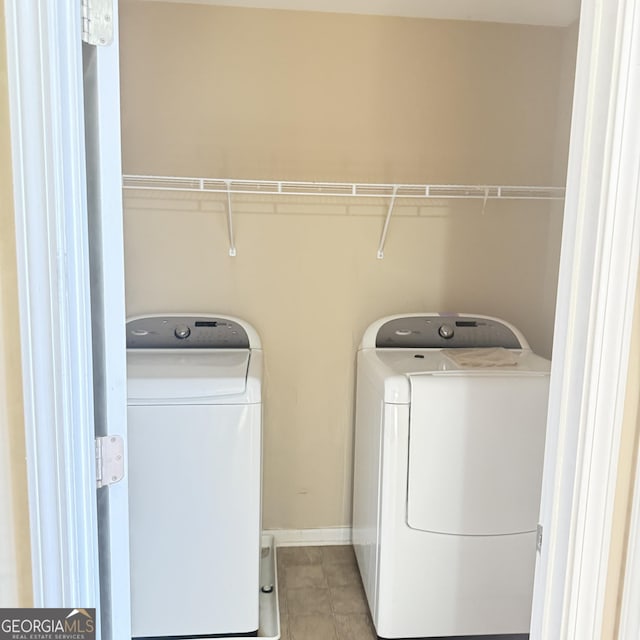 washroom featuring washer and dryer, laundry area, and tile patterned flooring
