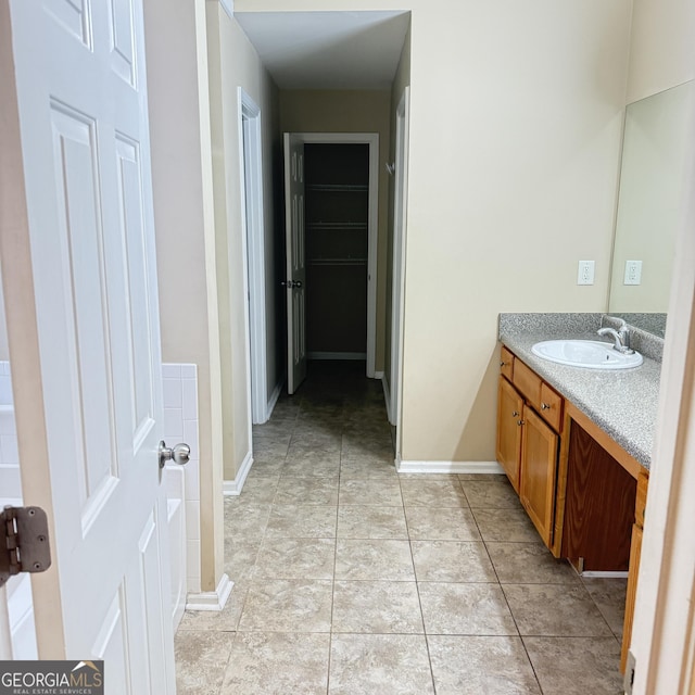 bathroom featuring baseboards and vanity