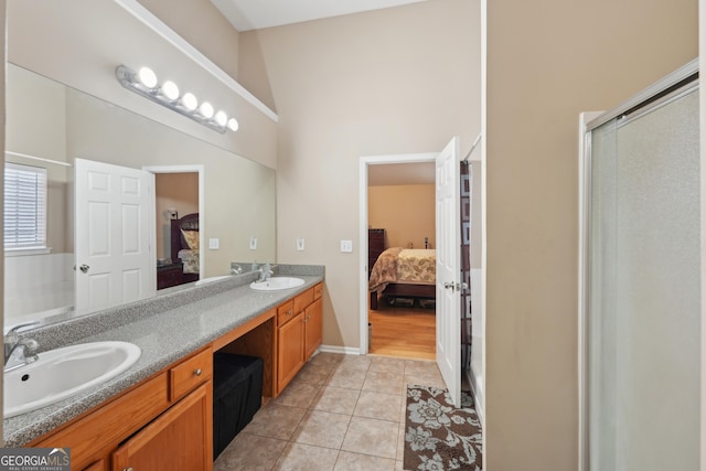 ensuite bathroom with double vanity, a sink, and ensuite bath