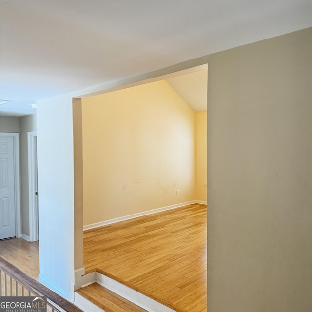 unfurnished room with light wood-type flooring and baseboards