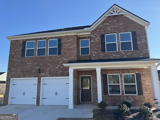 view of front of house with concrete driveway, brick siding, and an attached garage