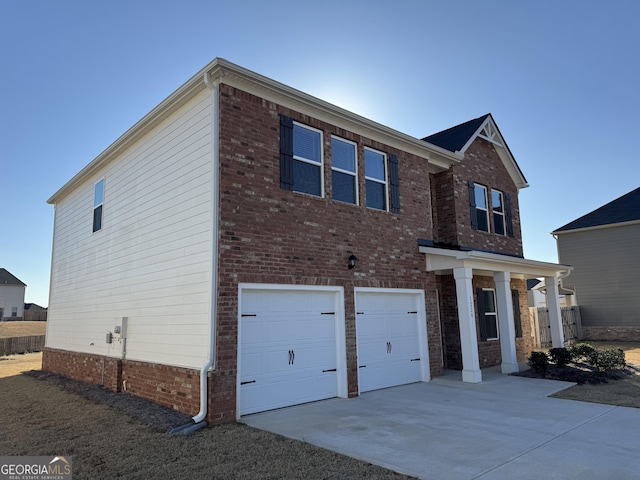 view of front of property featuring an attached garage, driveway, and brick siding