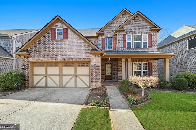 view of front of home with a garage, a front yard, brick siding, and driveway