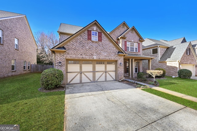 traditional-style home with brick siding, concrete driveway, a front yard, and fence