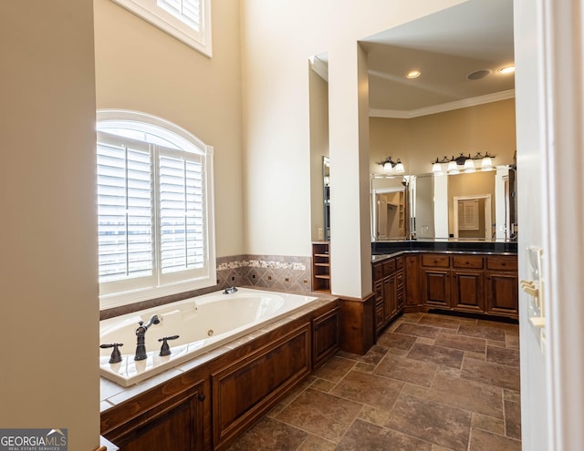 full bath featuring crown molding, recessed lighting, stone finish flooring, vanity, and a whirlpool tub