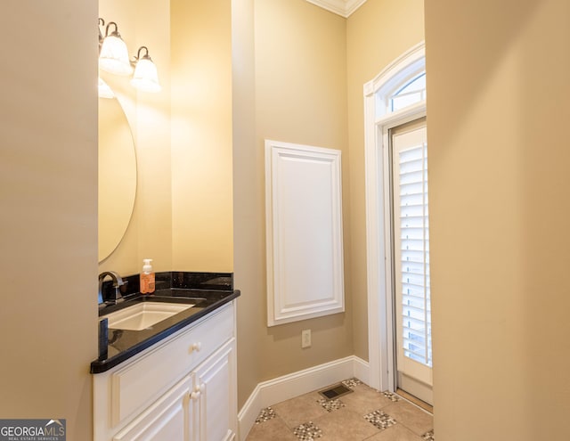 bathroom featuring visible vents, vanity, baseboards, and tile patterned floors