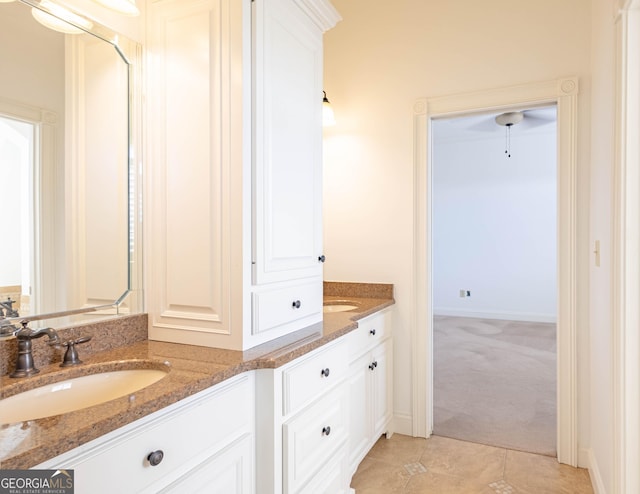 full bath featuring double vanity, a sink, and tile patterned floors