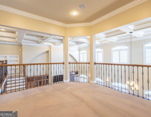 carpeted empty room with ornamental molding, coffered ceiling, and beam ceiling