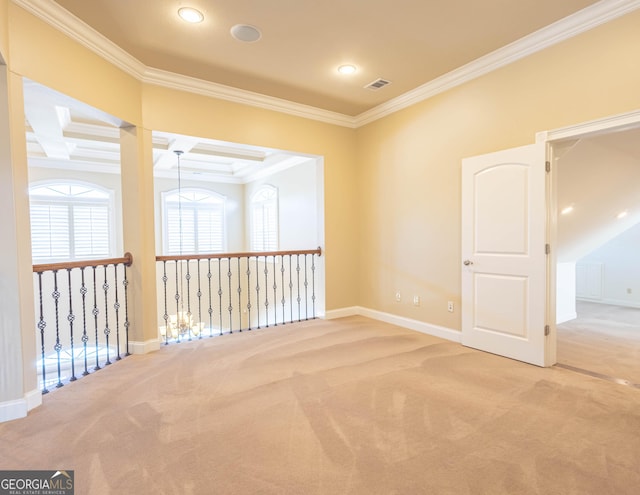 carpeted spare room with coffered ceiling, visible vents, and crown molding