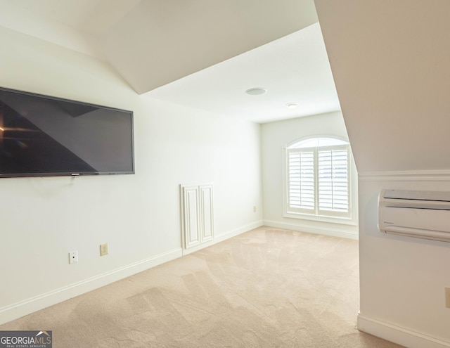 additional living space featuring carpet, baseboards, and a wall mounted air conditioner